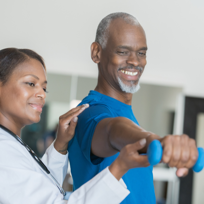 mature man exercising with dumbbells with female doctor