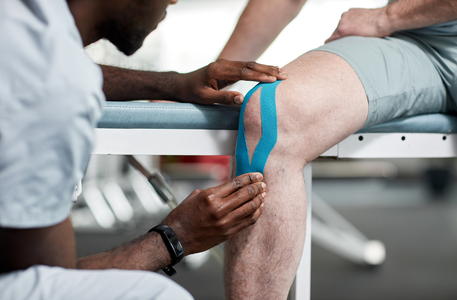 male doctor working on patients knee